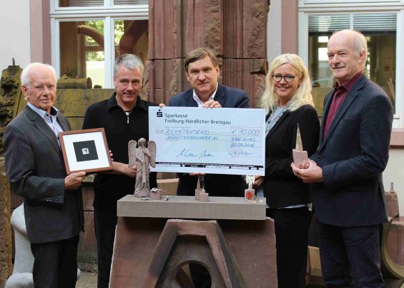 Die Juweliere (v.li.) Dieter und Stefan Lechler, Matthias Lewalter und Jürgen Wiedemann übergeben einen Spendenscheck über 10.000 Euro an Münsterbaumeisterin Yvonne Faller.